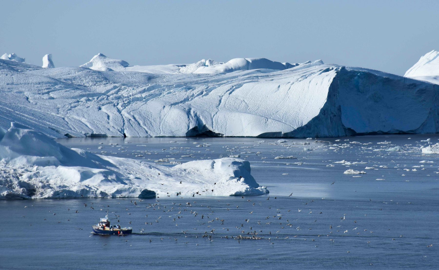 Glacier ice  and a fisherman